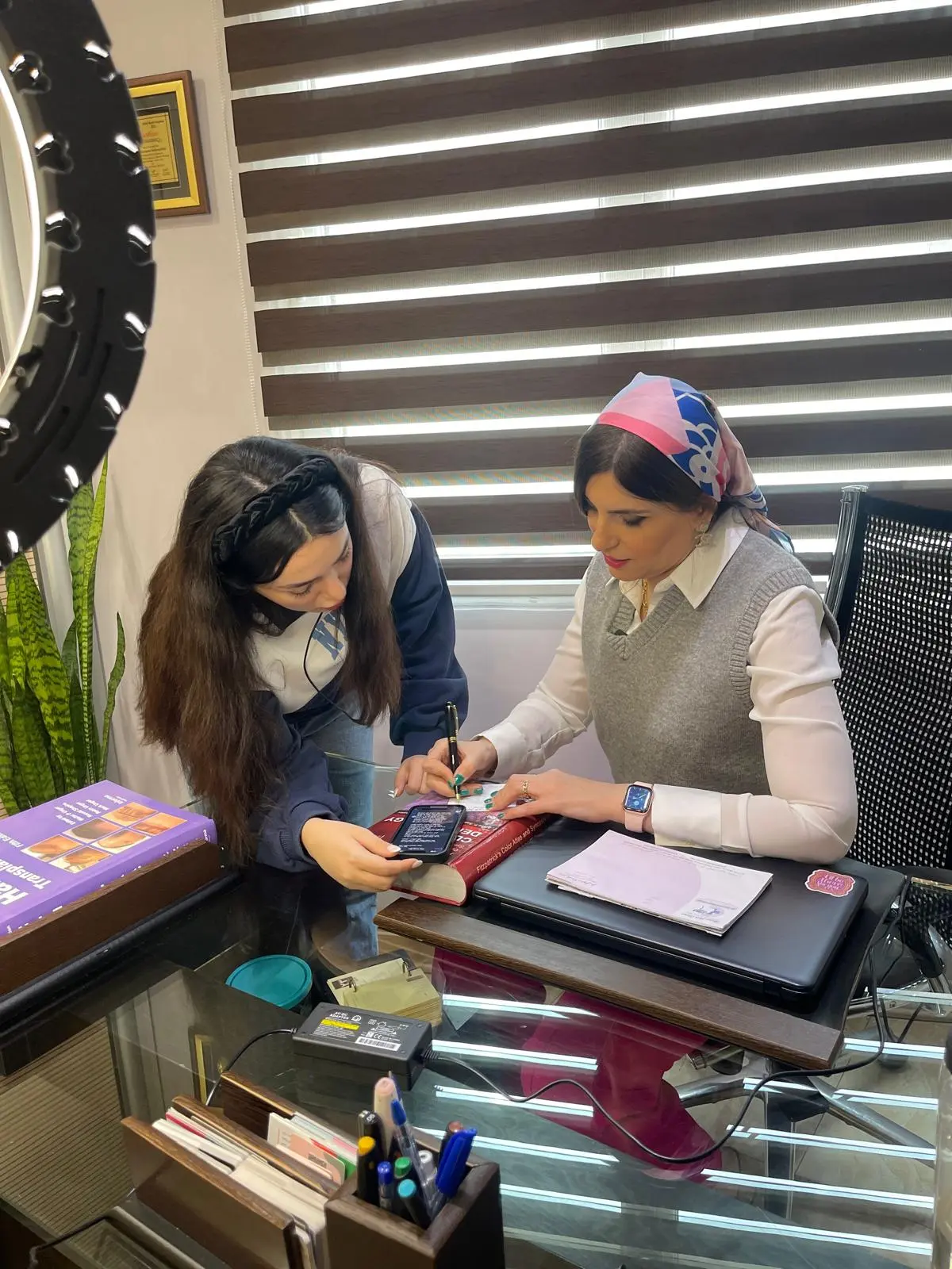 Dr. Roxanna Sadoughifar consulting with a patient at her hair transplant clinic in Tehran, Iran.
