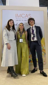 IMCAS World Congress 2026 in Paris featuring three medical professionals posing together at the event venue.